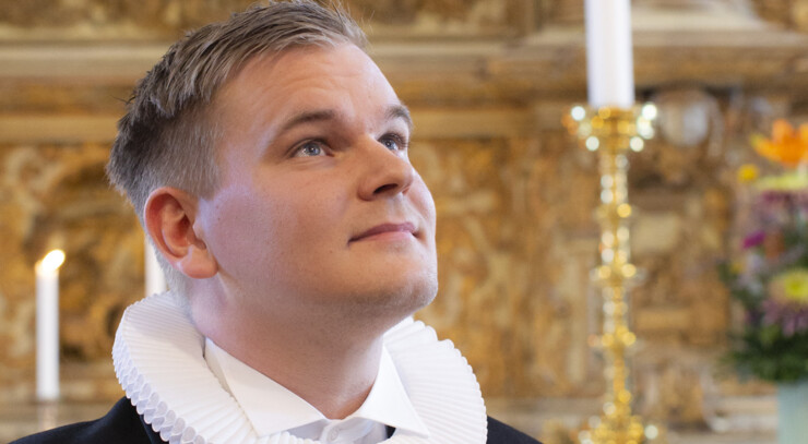 Kristoffer Hjort Kruse  foran altertavlen i Helsingør Domkirke